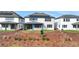A two-story home featuring solar panels and a covered patio at 6612 Quest St, St Cloud, FL 34771