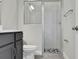A bathroom with a glass shower and gray vanity at 6612 Quest St, St Cloud, FL 34771