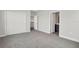 Bedroom showcasing plush gray carpet, white walls, and a view of the attached bathroom at 6612 Quest St, St Cloud, FL 34771