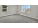 Bedroom features gray carpet, white walls, white trim, and two bright windows at 6612 Quest St, St Cloud, FL 34771
