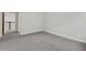 Bedroom showcasing gray carpet, white walls, white trim, and an open doorway at 6612 Quest St, St Cloud, FL 34771