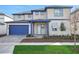 Charming two-story home featuring a blue garage door and trim and a manicured front lawn at 6612 Quest St, St Cloud, FL 34771