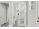 An airy hallway featuring double doors and neutral wall paint at 6612 Quest St, St Cloud, FL 34771
