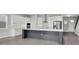 Modern kitchen with a large island, stainless appliances, and ample cabinet space for storage at 6612 Quest St, St Cloud, FL 34771
