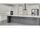 Kitchen boasts a large island, stainless appliances, white cabinets, and modern countertops at 6612 Quest St, St Cloud, FL 34771