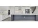 Bright kitchen featuring stainless appliances, a large island, and modern design elements at 6612 Quest St, St Cloud, FL 34771