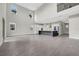 A large, open-concept living room featuring gray flooring, white walls, and modern kitchen with an oversized island at 6612 Quest St, St Cloud, FL 34771