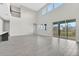 Bright living area with high ceilings, large windows, and a seamless transition to the outdoors at 6612 Quest St, St Cloud, FL 34771