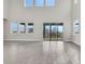 Open living space features high ceilings, a wall of windows, and access to the outdoor area at 6612 Quest St, St Cloud, FL 34771