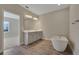 Modern bathroom with double vanity, soaking tub, and wood tile flooring, creating a spa-like retreat at 6616 Quest St, Saint Cloud, FL 34771