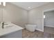 Bright bathroom featuring a double vanity, soaking tub, and tile flooring, creating a stylish retreat at 6616 Quest St, St Cloud, FL 34771