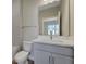 Bathroom featuring a single vanity with white countertop, framed mirror, and tile flooring at 6616 Quest St, St Cloud, FL 34771