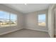 Bedroom with two large windows and neutral walls and carpet, providing ample natural light at 6616 Quest St, St Cloud, FL 34771
