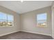 Simple bedroom featuring wood-look flooring, ample natural light from two windows, and a closet for storage at 6616 Quest St, St Cloud, FL 34771