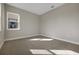 Neutral-toned bedroom with carpet flooring and a bright window; a blank canvas ready for personal touches at 6616 Quest St, St Cloud, FL 34771