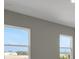 Bedroom with two large windows and neutral walls, providing ample natural light at 6616 Quest St, St Cloud, FL 34771