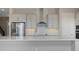 Kitchen with light-colored cabinetry, stainless steel appliances and a large island offering plenty of counter space at 6616 Quest St, St Cloud, FL 34771
