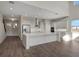 Open concept kitchen with large center island, stainless appliances, and hardwood floors throughout the living space at 6616 Quest St, St Cloud, FL 34771