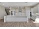 Bright open-concept kitchen with stainless appliances, light cabinetry, and an expansive island for dining at 6616 Quest St, St Cloud, FL 34771