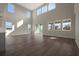 Expansive living room with soaring ceilings, numerous windows, and tile floors, perfect for entertaining or relaxing at 6616 Quest St, St Cloud, FL 34771