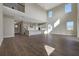 Spacious open-concept living area with a large kitchen, high ceilings, and abundant natural light from large windows at 6616 Quest St, St Cloud, FL 34771