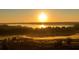 Scenic aerial view of the community golf course at sunrise at 15615 Vetta Dr, Montverde, FL 34756