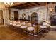 Stone bar area featuring a wood bar, seating, and lighting at 15615 Vetta Dr, Montverde, FL 34756