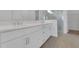 Bathroom featuring a double vanity, sleek cabinets, and glass-enclosed shower at 15615 Vetta Dr, Montverde, FL 34756