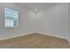 This bedroom has light, airy walls, laminate flooring, and a large window at 15615 Vetta Dr, Montverde, FL 34756