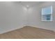 A bedroom with white walls, laminate flooring, white trim, and a window at 15615 Vetta Dr, Montverde, FL 34756