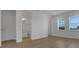 A bedroom with white walls, laminate flooring, and two windows at 15615 Vetta Dr, Montverde, FL 34756