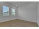 Bright bedroom with hardwood floors and two windows at 15615 Vetta Dr, Montverde, FL 34756