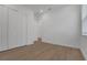 A bedroom with white walls, laminate flooring, white trim, and closet at 15615 Vetta Dr, Montverde, FL 34756