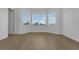 Bright bedroom with plank flooring and three windows at 15615 Vetta Dr, Montverde, FL 34756