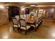 Elegant dining room featuring a long wooden table, brick ceiling, and stylish decor, perfect for hosting dinner parties at 15615 Vetta Dr, Montverde, FL 34756