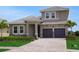 Charming two-story home featuring a tile roof and a two car garage at 15615 Vetta Dr, Montverde, FL 34756