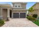 Well-maintained two-story home with tile roof, two-car garage, and landscaped yard at 15615 Vetta Dr, Montverde, FL 34756