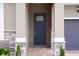 Stylish front entry with a modern door framed by stone accents and a brick walkway at 15615 Vetta Dr, Montverde, FL 34756