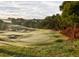 Lush golf course fairway with strategically placed sand traps and mature trees, offering a challenging and scenic experience at 15615 Vetta Dr, Montverde, FL 34756