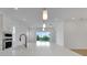 Bright kitchen featuring white countertops, modern faucet, and a view of the pool at 15615 Vetta Dr, Montverde, FL 34756