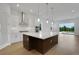 Bright kitchen with white cabinetry, large island, stainless steel appliances and sliding glass doors at 15615 Vetta Dr, Montverde, FL 34756