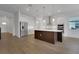 Kitchen featuring white cabinets, stainless steel appliances, and island with wood-look paneling at 15615 Vetta Dr, Montverde, FL 34756