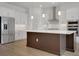 Bright modern kitchen with white cabinetry, stainless steel appliances and center island at 15615 Vetta Dr, Montverde, FL 34756