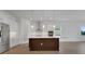 Contemporary kitchen featuring white cabinets, stainless steel appliances, and center island at 15615 Vetta Dr, Montverde, FL 34756