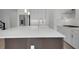 Modern kitchen with white cabinets and a large kitchen island with a sink at 15615 Vetta Dr, Montverde, FL 34756