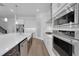 Modern kitchen with stainless steel appliances, white cabinets, and a large kitchen island at 15615 Vetta Dr, Montverde, FL 34756