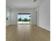 Spacious living room with hardwood floors and sliding glass doors to the backyard at 15615 Vetta Dr, Montverde, FL 34756