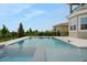 A beautiful pool and patio surrounded by lush greenery offering a serene escape at 15615 Vetta Dr, Montverde, FL 34756