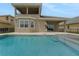 Back exterior of the house showing the pool and outdoor kitchen at 15615 Vetta Dr, Montverde, FL 34756