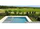 Modern pool and hot tub with views of a lush golf course, perfect for relaxation and entertainment at 15615 Vetta Dr, Montverde, FL 34756